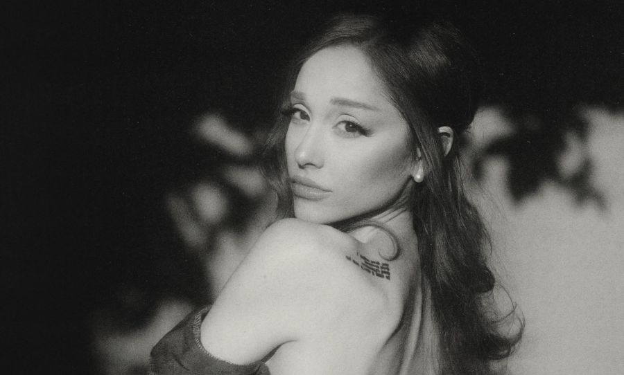 Black-and-white portrait of Ariana Grande looking over her shoulder